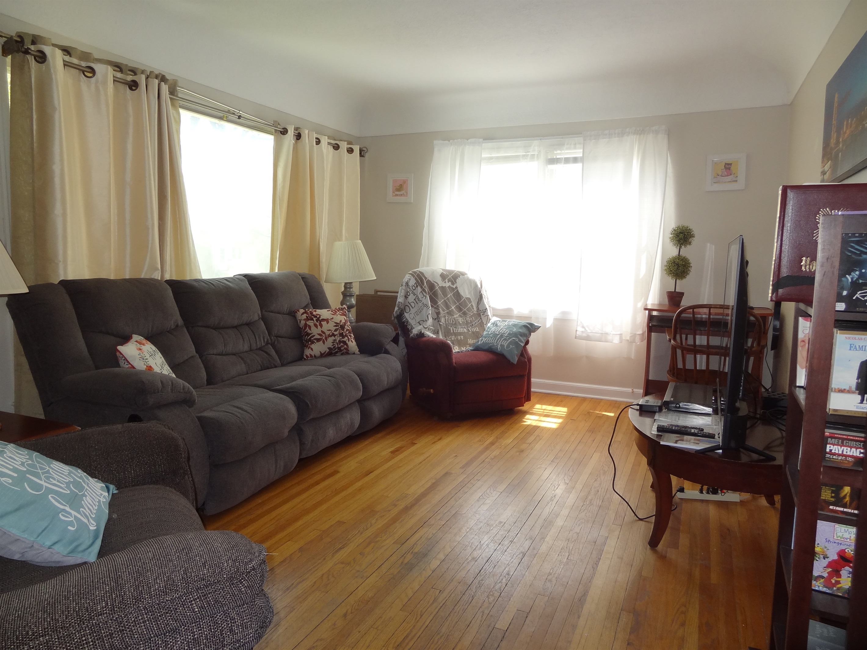 Living room with couch, recliners, and Roku smart TV