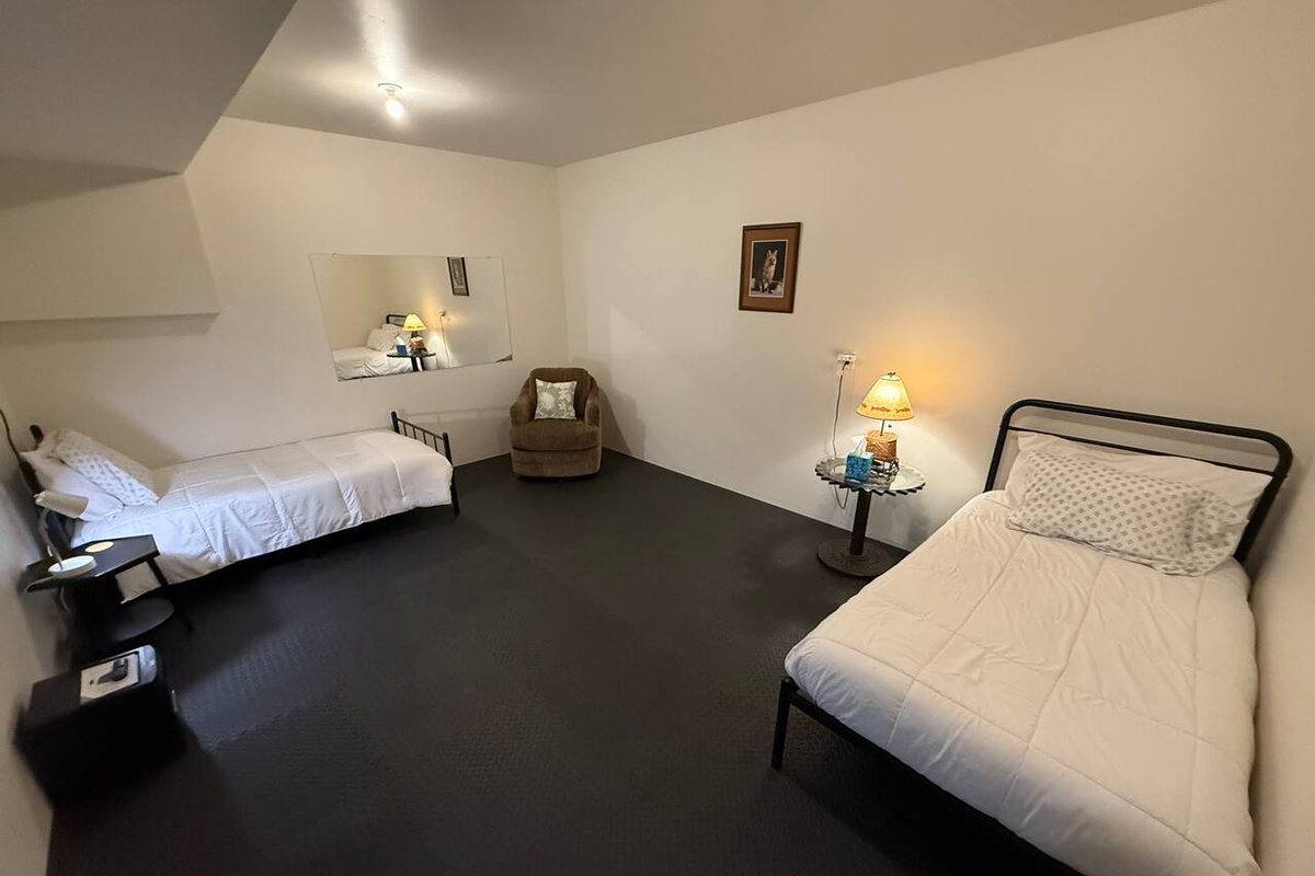 basement bedroom with two twin beds (no closet)