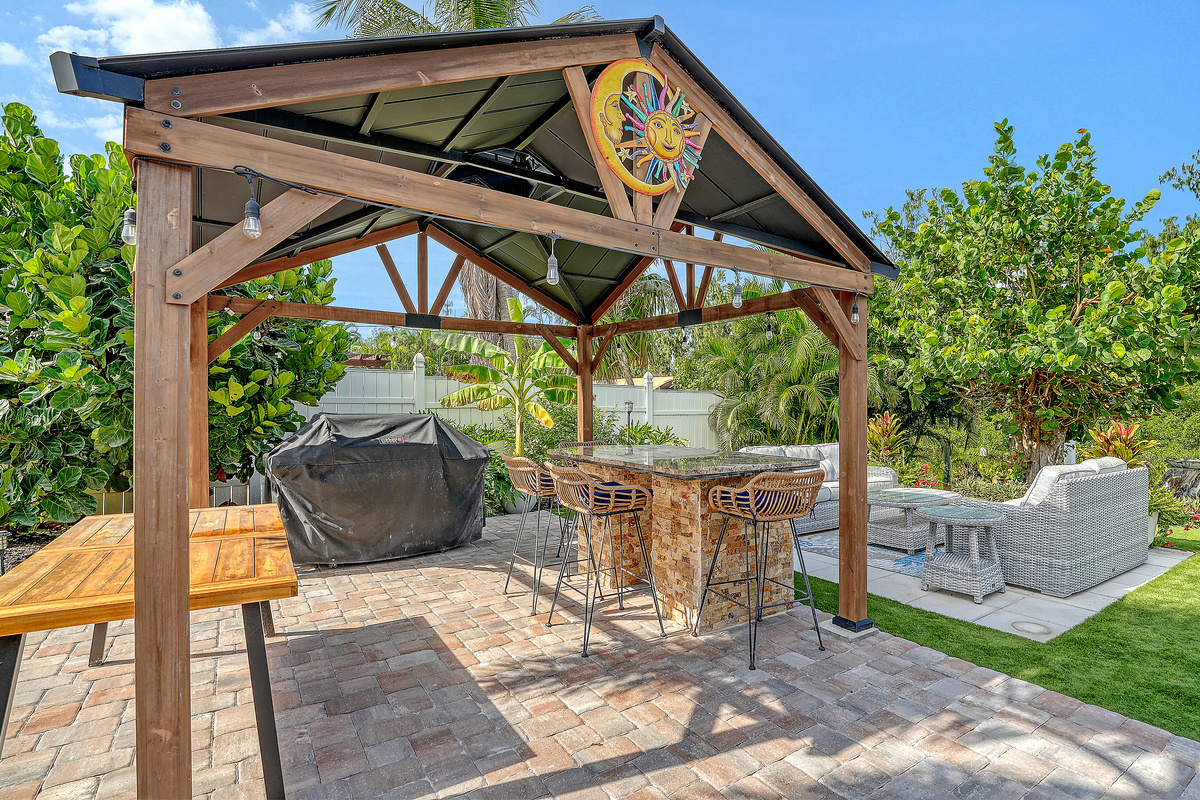 Come for the beaches and stay for the backyard! This is a covered bar area with the grill. 