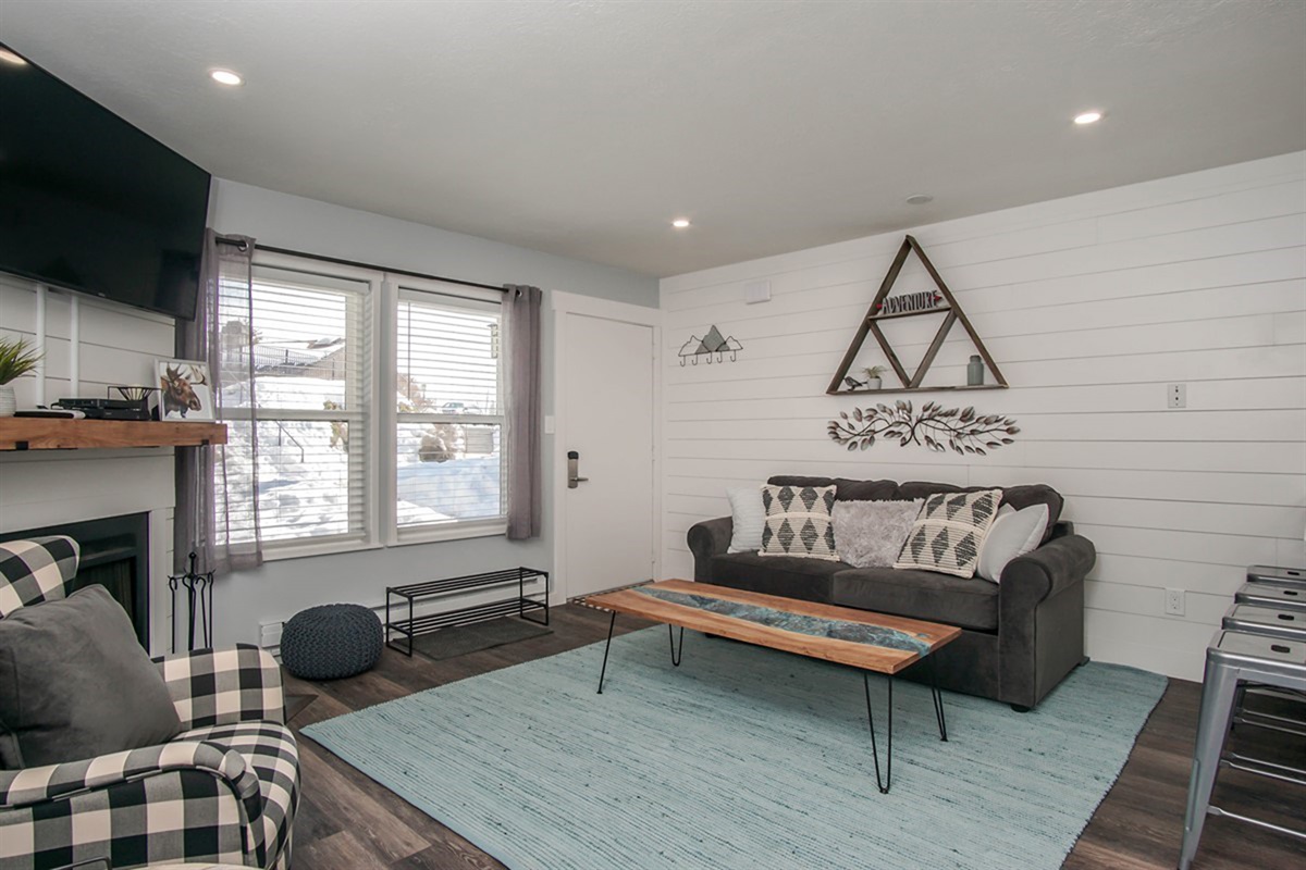 Unwind in this welcoming living area with large windows bringing in natural light and mountain charm.