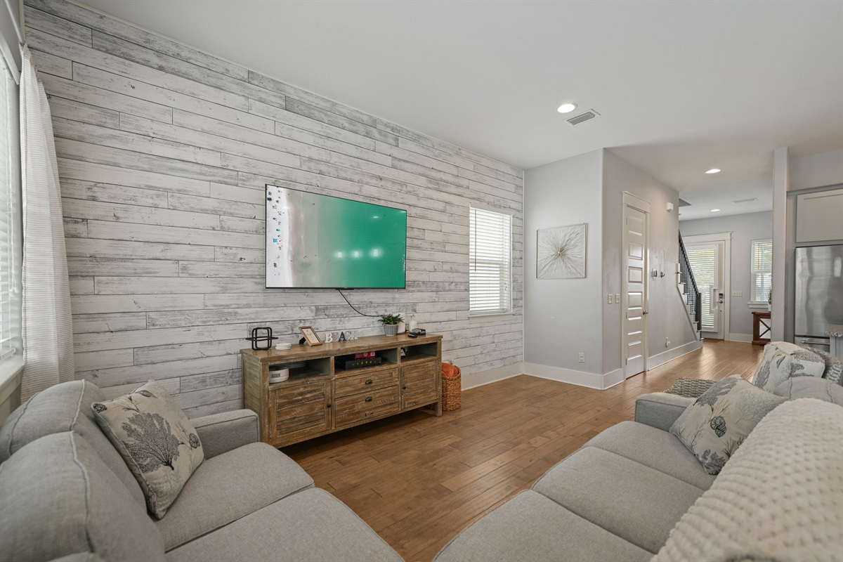 Comfortable living room with sectional seating and wall-mounted TV.