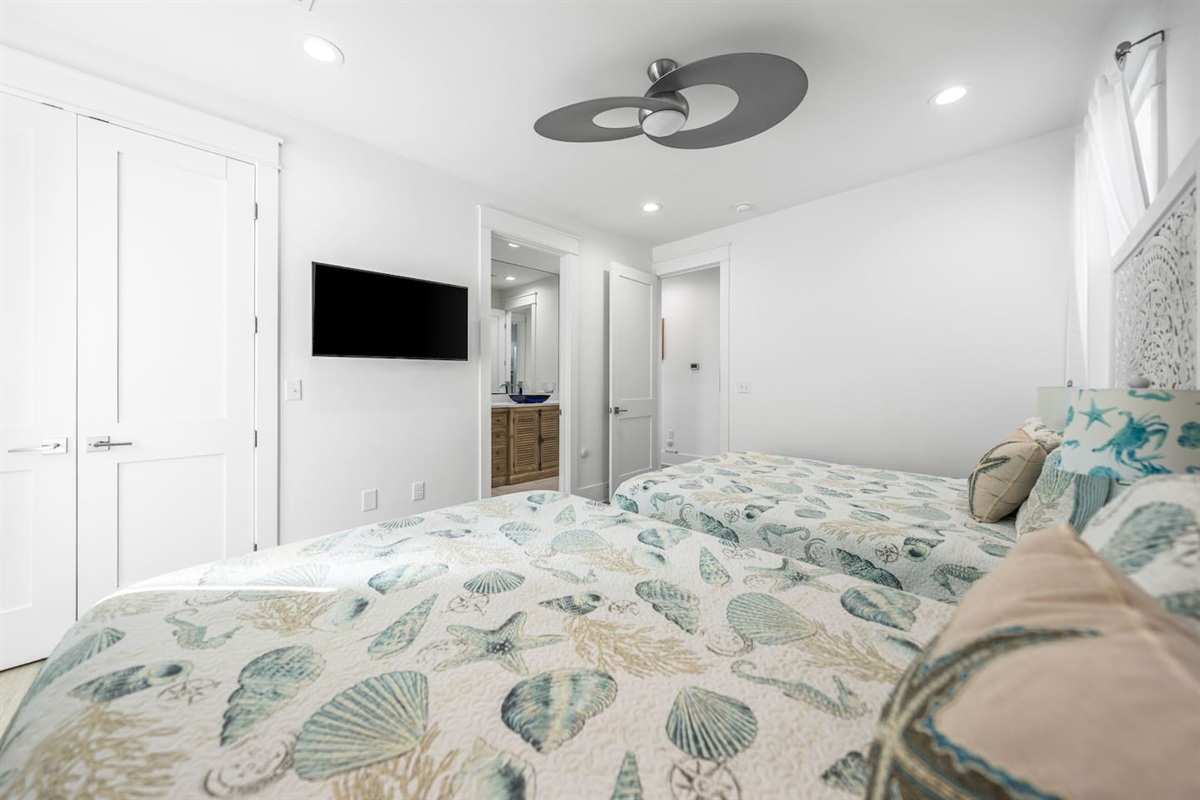 Experience 30A comfort in our second suite!   Two Queen beds (sleeps 4) with comfortable linens, a high-power Supersonic fan, and a Smart TV /  attache to designer bath, it’s the ultimate setup for those  seeking a pristine, AC-cooled retreat.