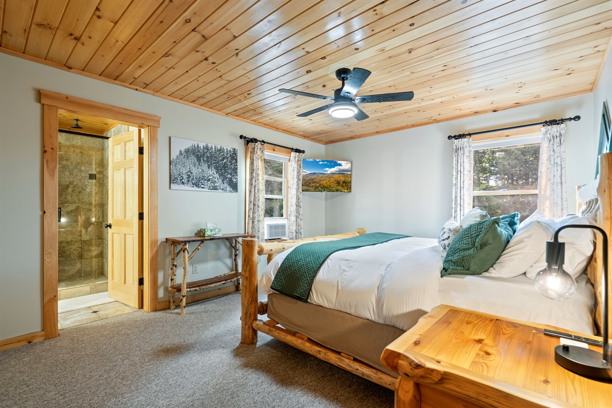 The first bedroom boasts a spacious king bed for a restful night’s sleep.