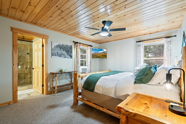 The first bedroom boasts a spacious king bed for a restful night’s sleep.