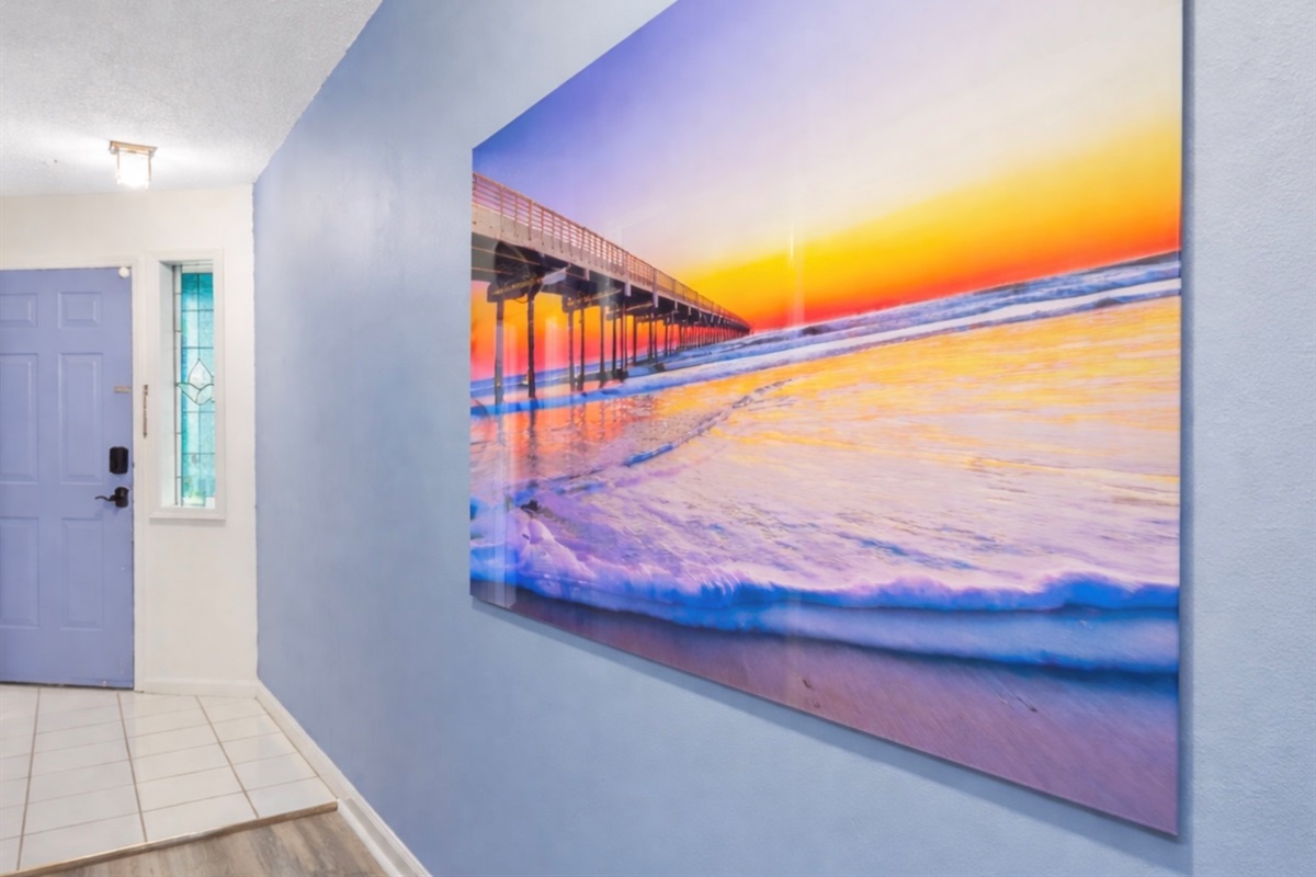A stunning Garden City Pier artwork greets you in the hallway ✨ A daily reminder of what awaits at sunrise just across the street — soft coastal light, rolling waves, and the peaceful rhythm of the ocean.