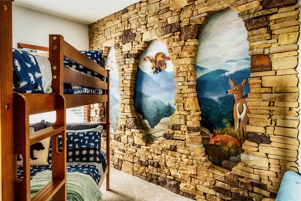 Whimsical Bunk Room with Stone Wall Mural—Perfect for Kids’ Sleepovers in the Smokies.