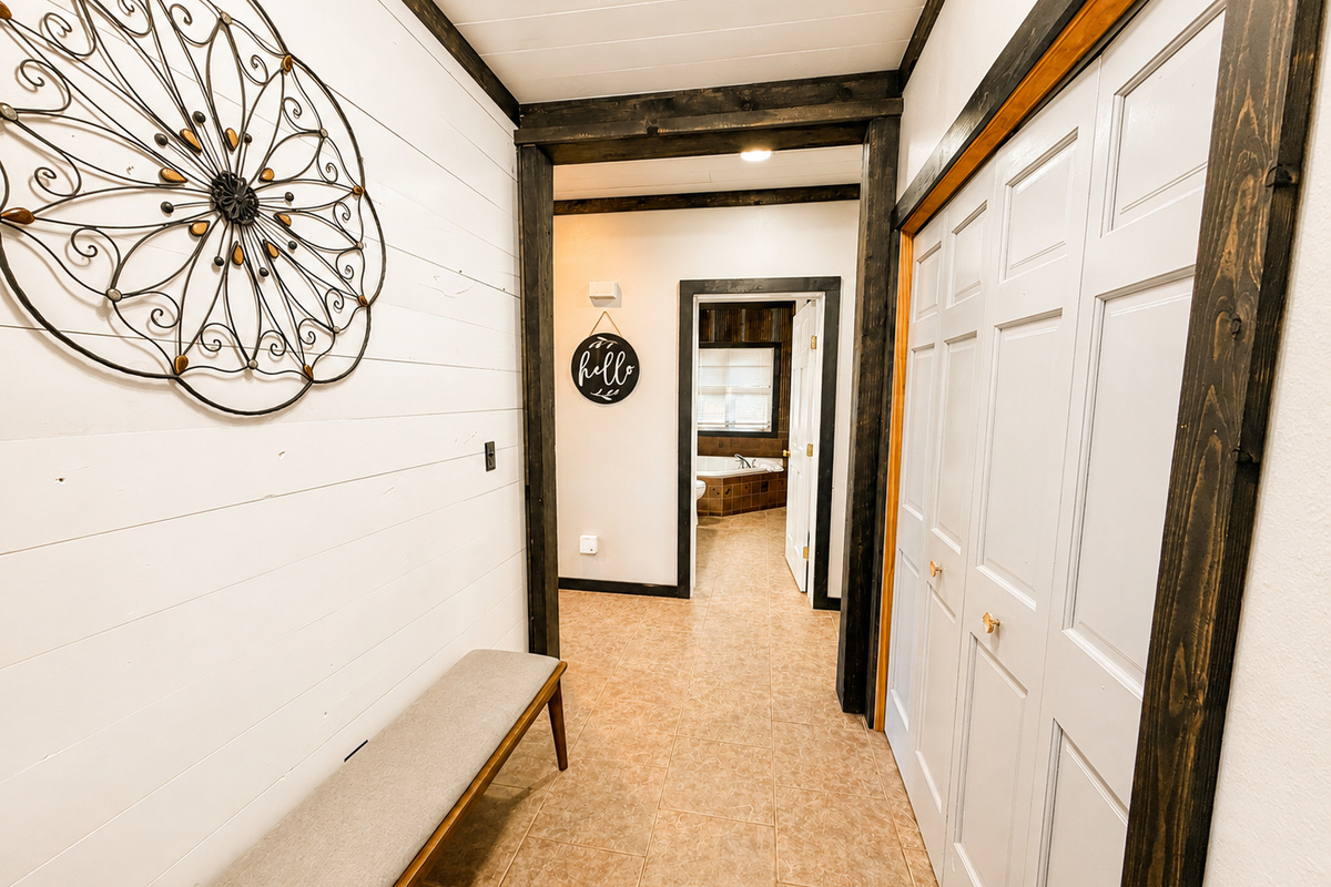 Bright entry hallway with convenient storage connects you to the kitchen, main living room, sleeping spaces and bathroom straight ahead.
