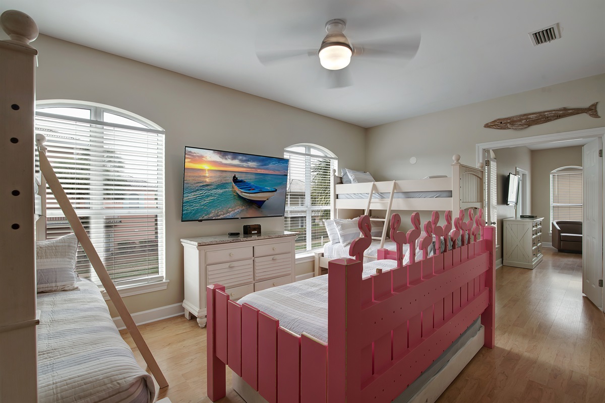 Second bunk room with twin‑over‑twin beds and bright windows