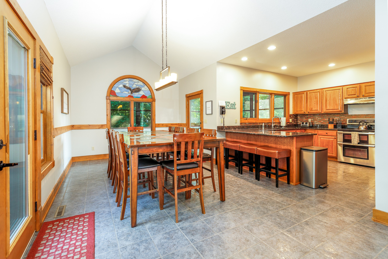 Dining room table seats up to 10 with 4 additional stools at breakfast bar