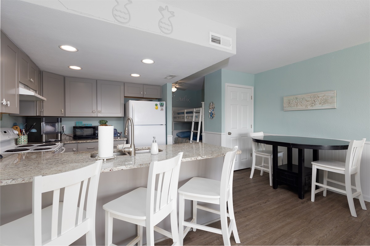 Breakfast bar and dining table offering plenty of seating for meals and gatherings