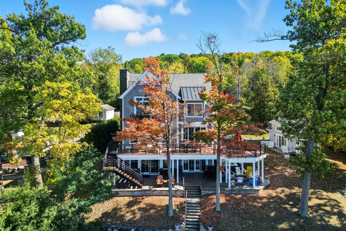 Lakeside exterior of the home with multiple decks and lake access.