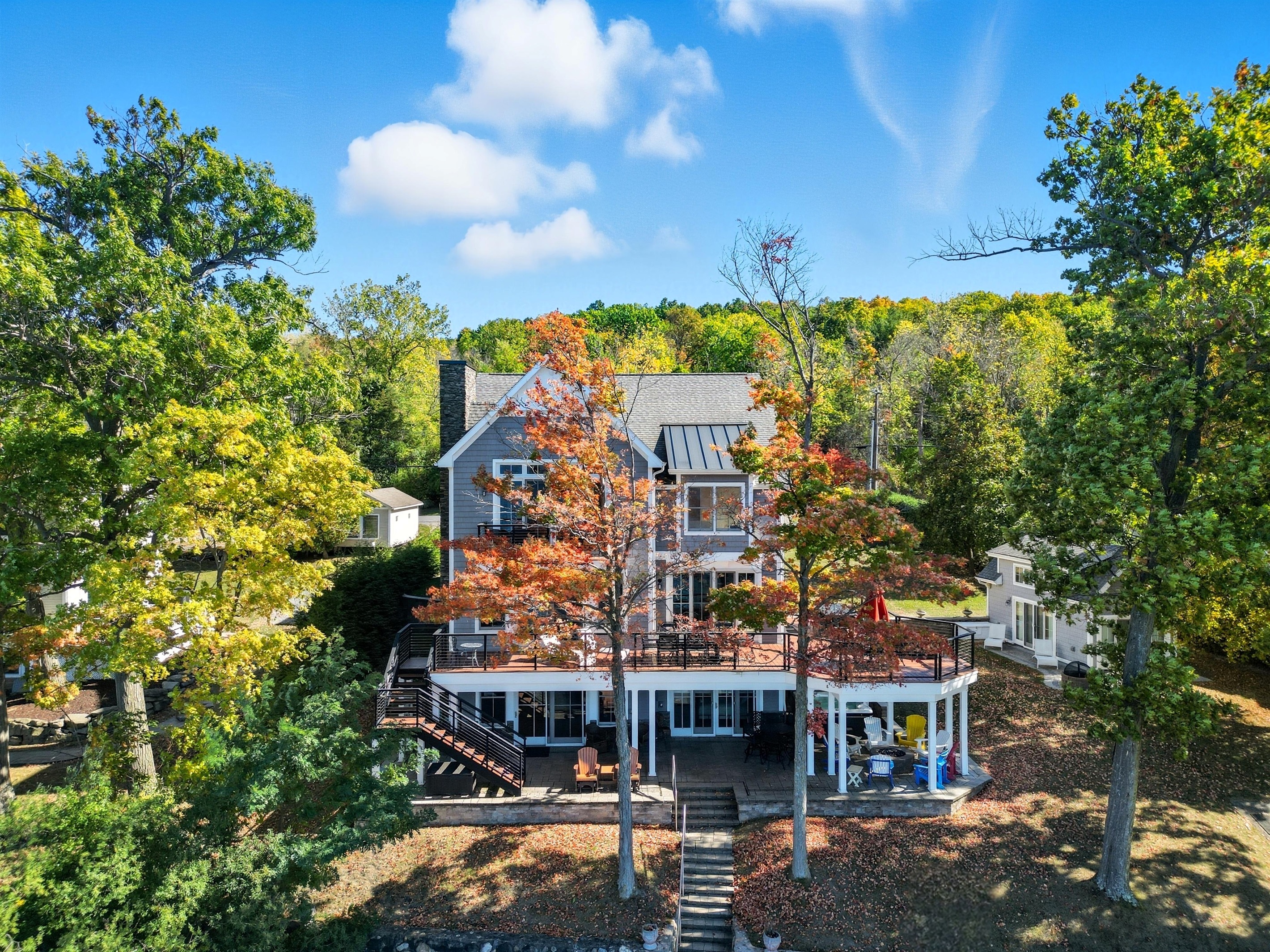 Lakeside exterior of the home with multiple decks and lake access.