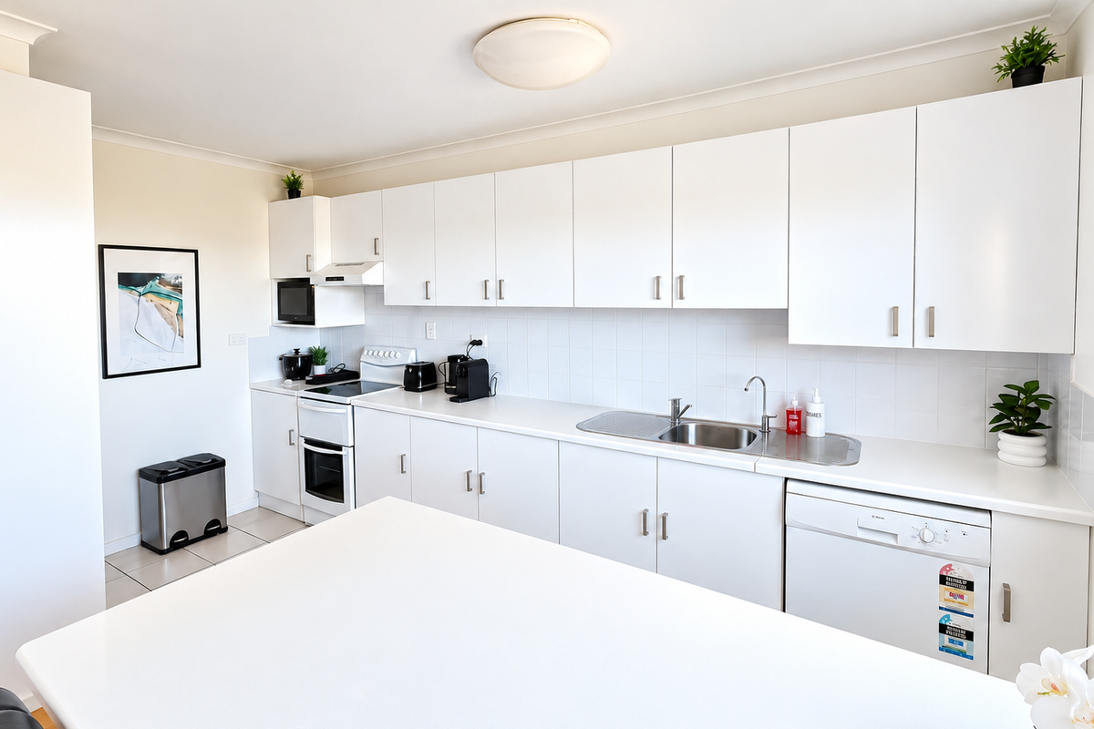 The spacious kitchen at Carlenes Getaway offers ample workspace and storage, with an oven, dishwasher and convenient countertop appliances.
