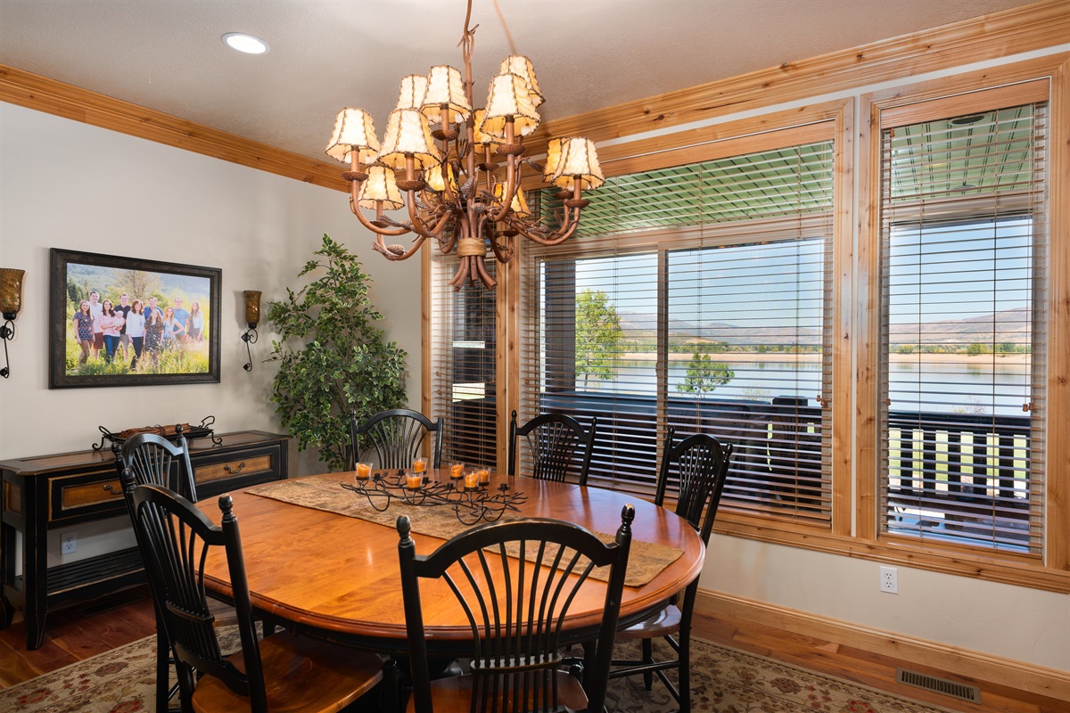 Cozy dining space with elegant lighting and scenic window views of Pineview Reservoir.