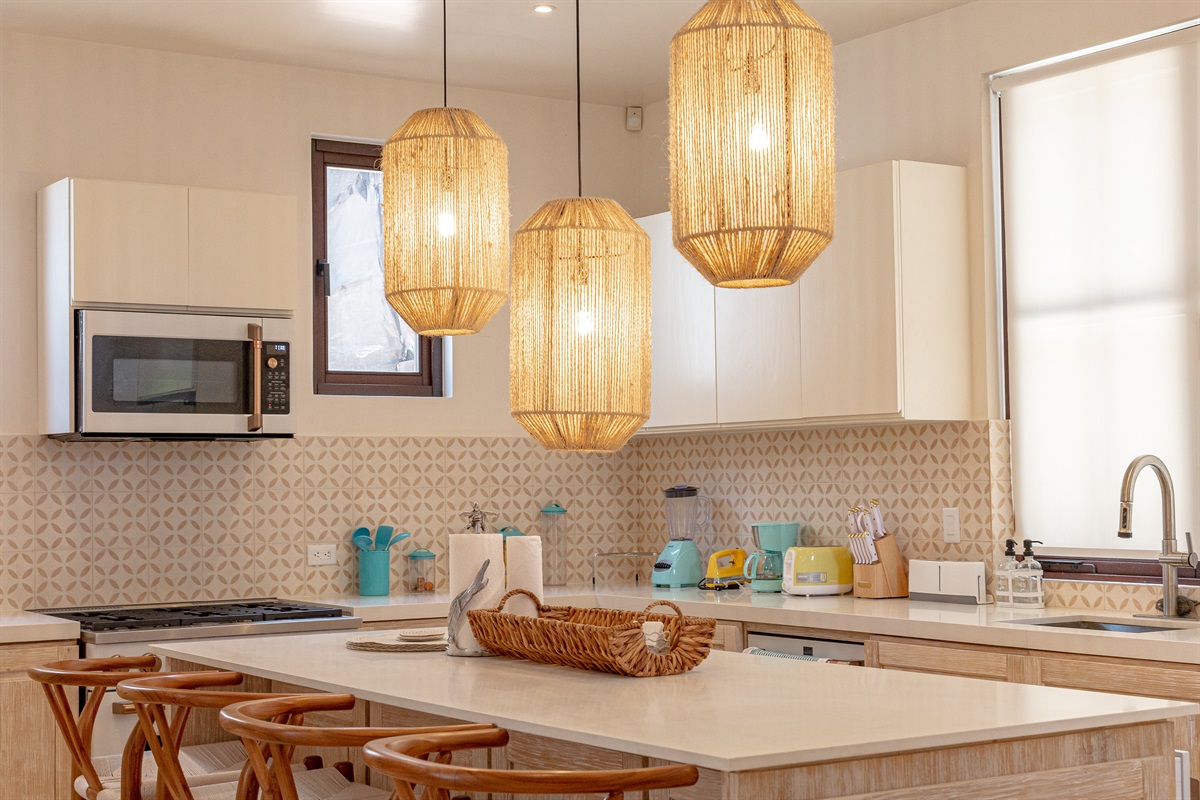 Located in the right wing of the home, the fully equipped kitchen has a gas stove and large island perfect for gathering.