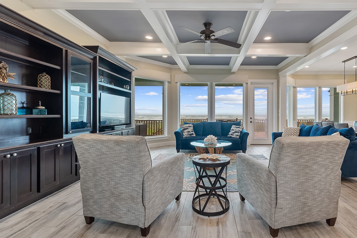 1st Floor Living Room: Spacious with custom coffered ceilings and panoramic Gulf views.