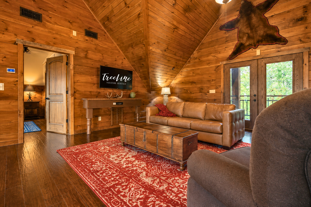 An upstairs sitting area creates another cozy place to unwind, giving the group extra room to spread out beyond the main living space downstairs.