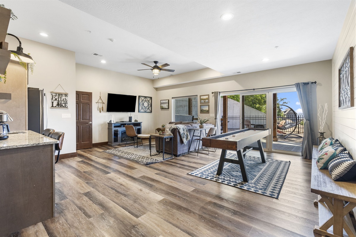 Lower level living room with PS4 and shuffleboard table