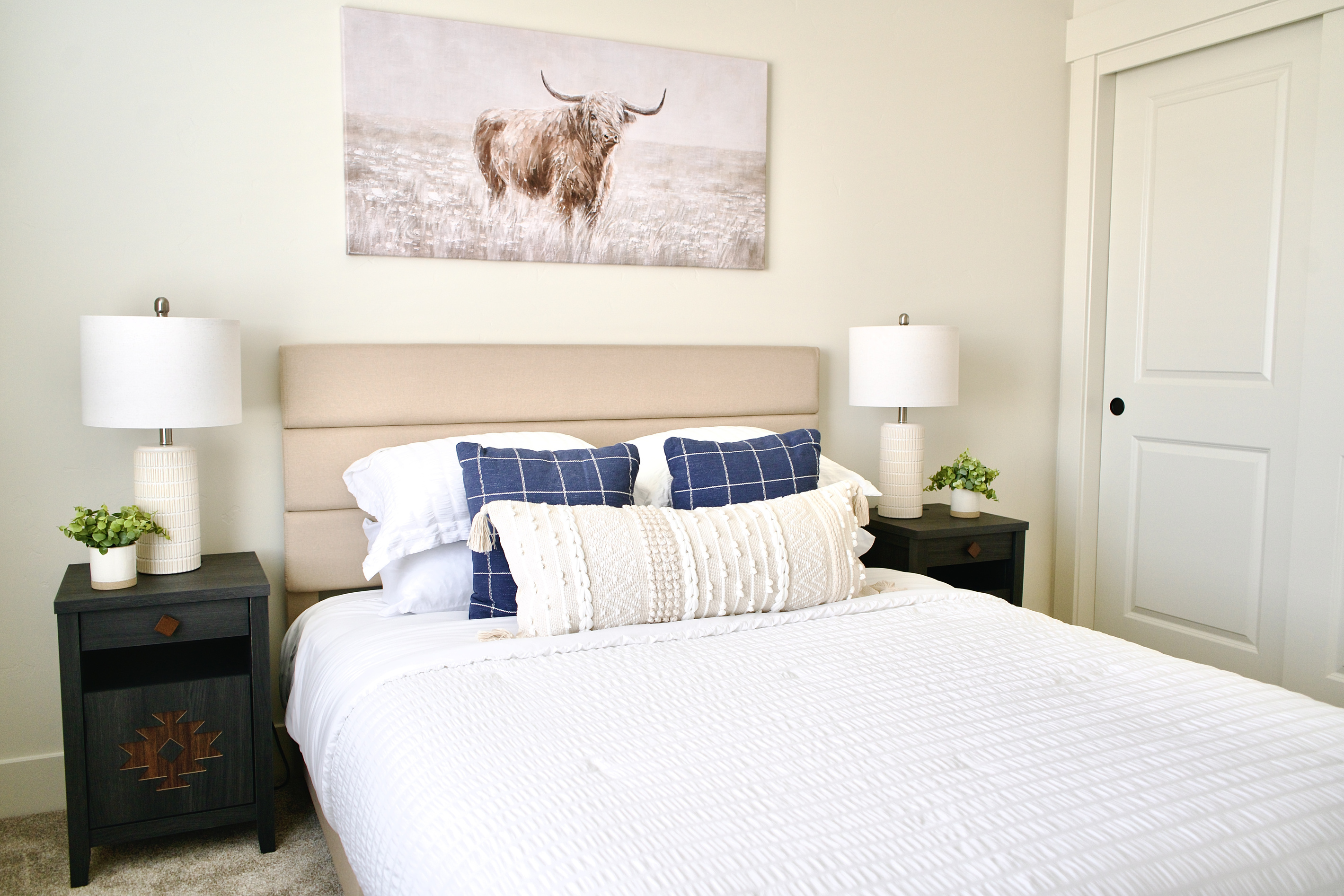 Second bedroom upstairs, furnished with a queen bed and bedside tables on both sides. This room features spacious closets and is thoughtfully designed with elegant, stylish finishes.