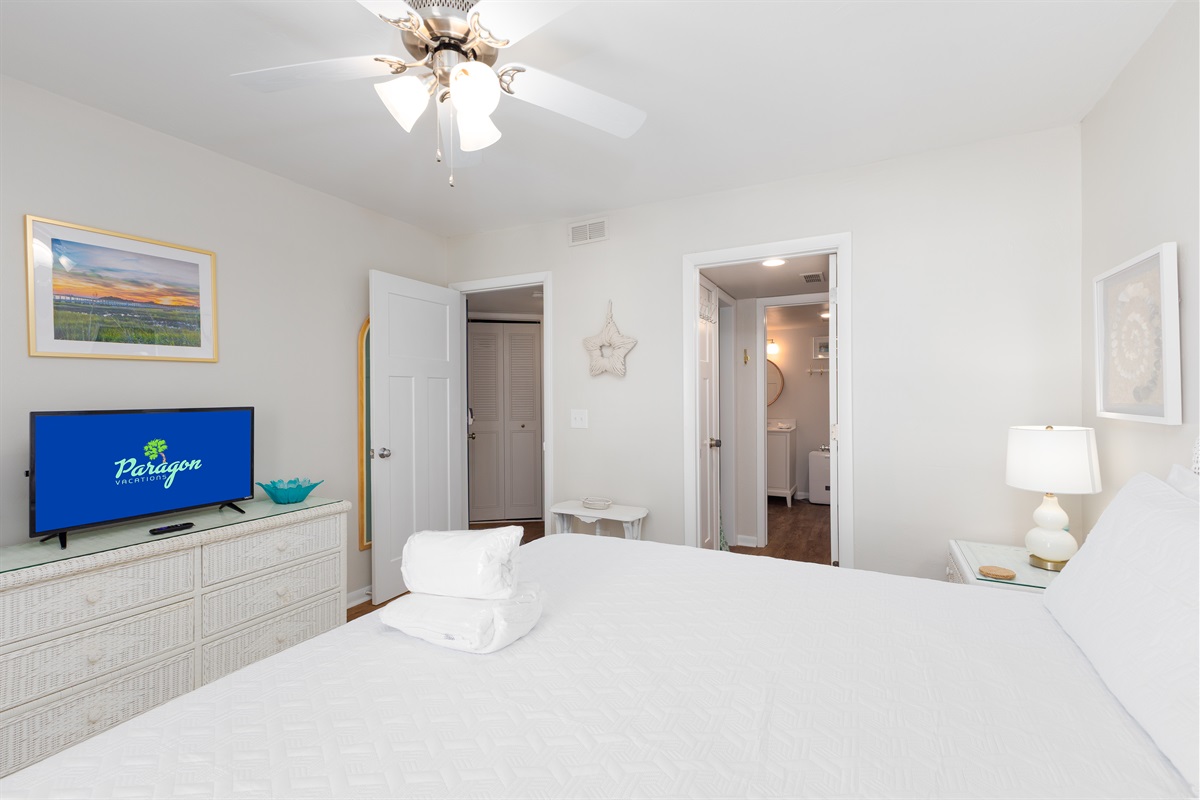 Master bedroom with TV, dresser, and relaxing atmosphere