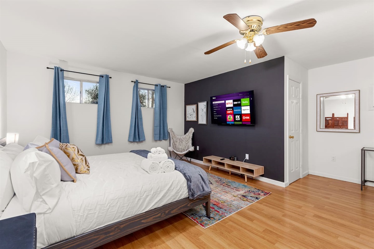 Cozy up in our inviting bedroom, featuring plush bedding and a smart TV for the ultimate comfort and entertainment during your stay.