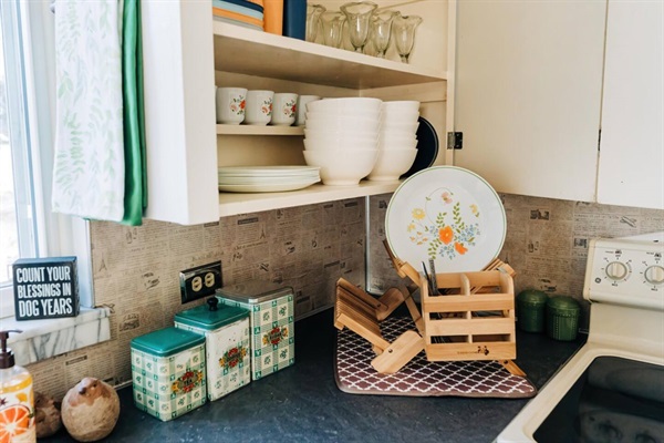 Vintage Corelle, giant ceral/soup bowls, plastic children's plates, and all the handy gadgets for washing dishes (Old fashioned homes come with old-fashioned chores - dish washing is done by hand).