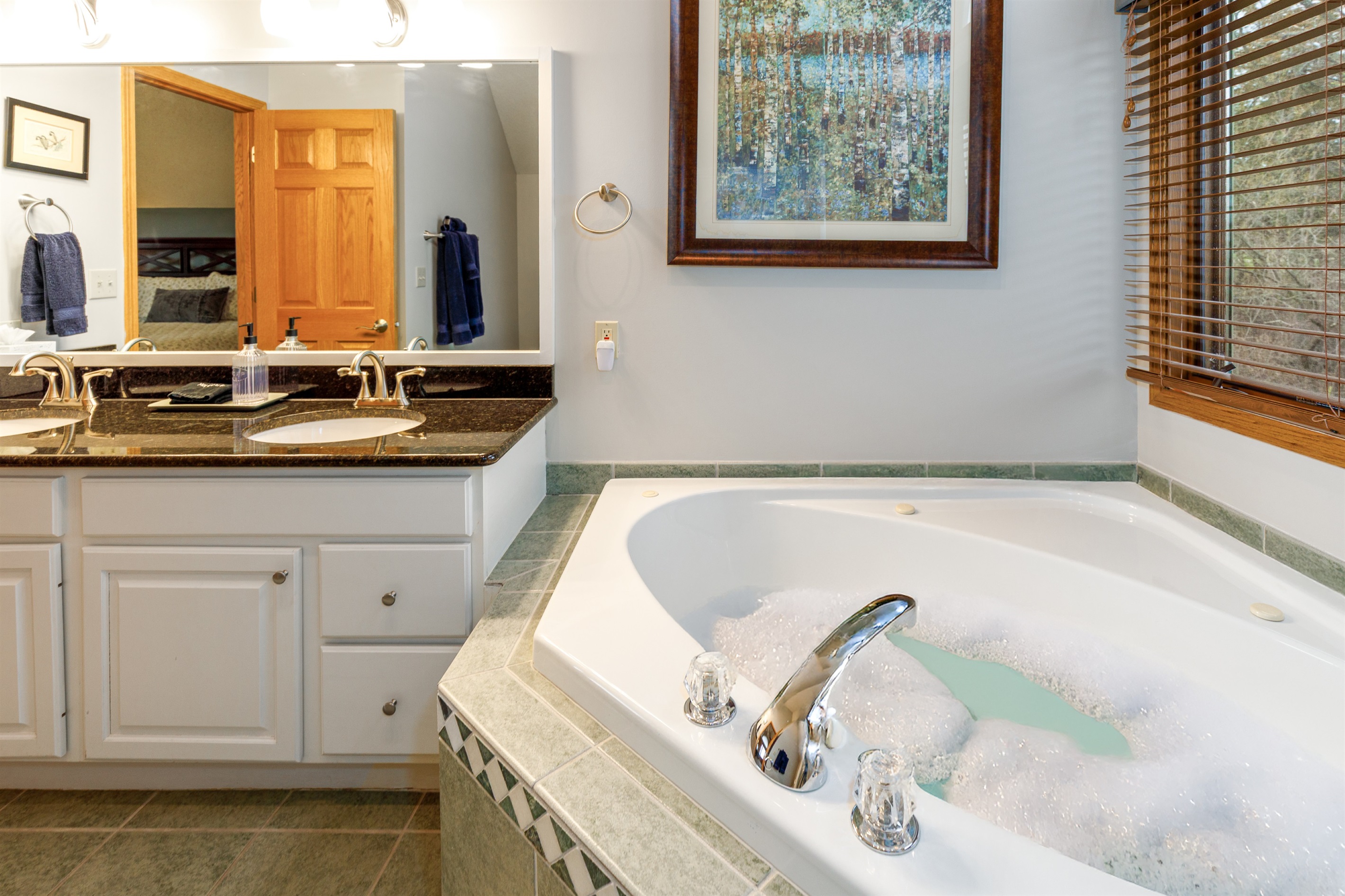 Large Primary bath with double vanity, soaking tub, and separate shower