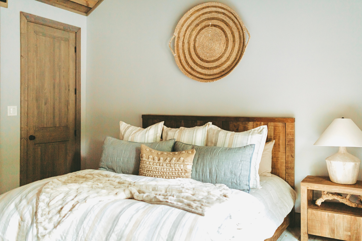 King suite with a vaulted ceiling and warm wood accents.
