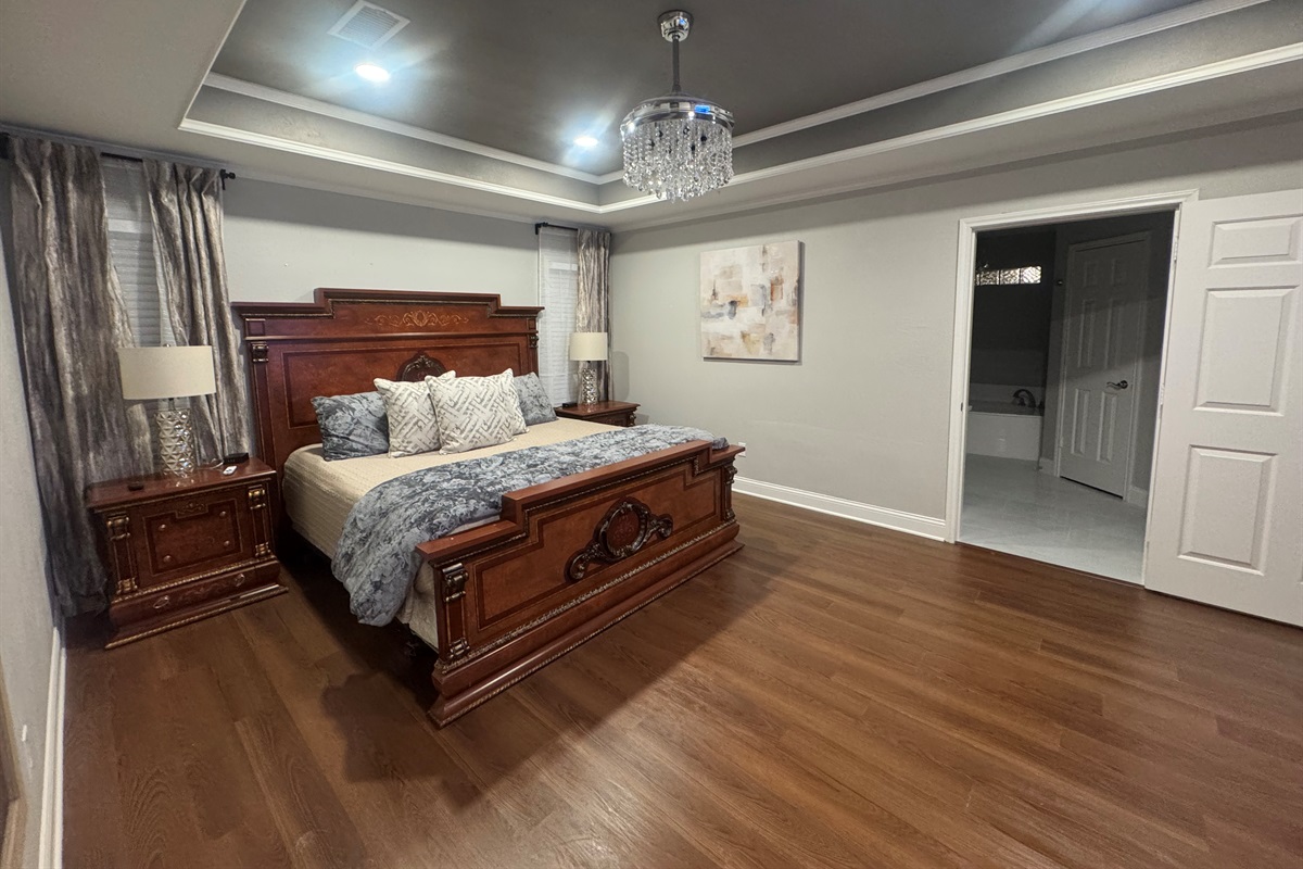 Primary Bedroom w/65 TV and Ensuite Bathroom