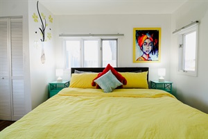 A bedroom designed with adequate lighting, creating a bright and welcoming space that enhances comfort and ambiance, perfect for both relaxation and reading.
