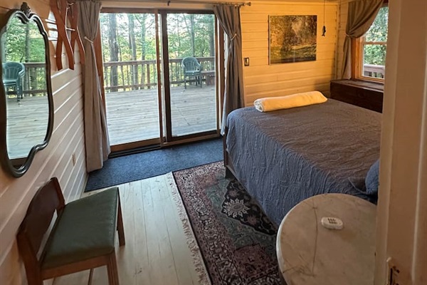 Rest easy in the main double  bedroom, complete with soft linens, blackout curtains, and charming cabin views. Quiet, private, and ideal for a good night’s sleep after a day outdoors.