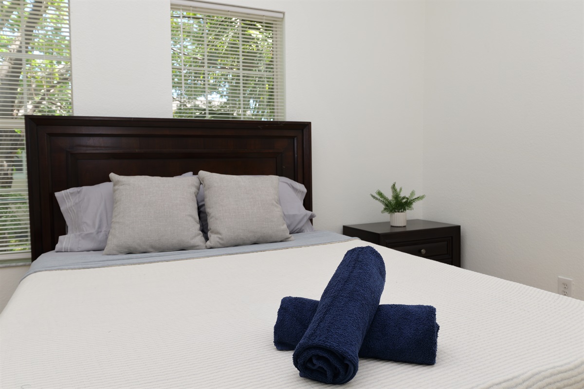 With a rich wood headboard and minimalist touches, this stylish bedroom balances modern simplicity with total comfort.