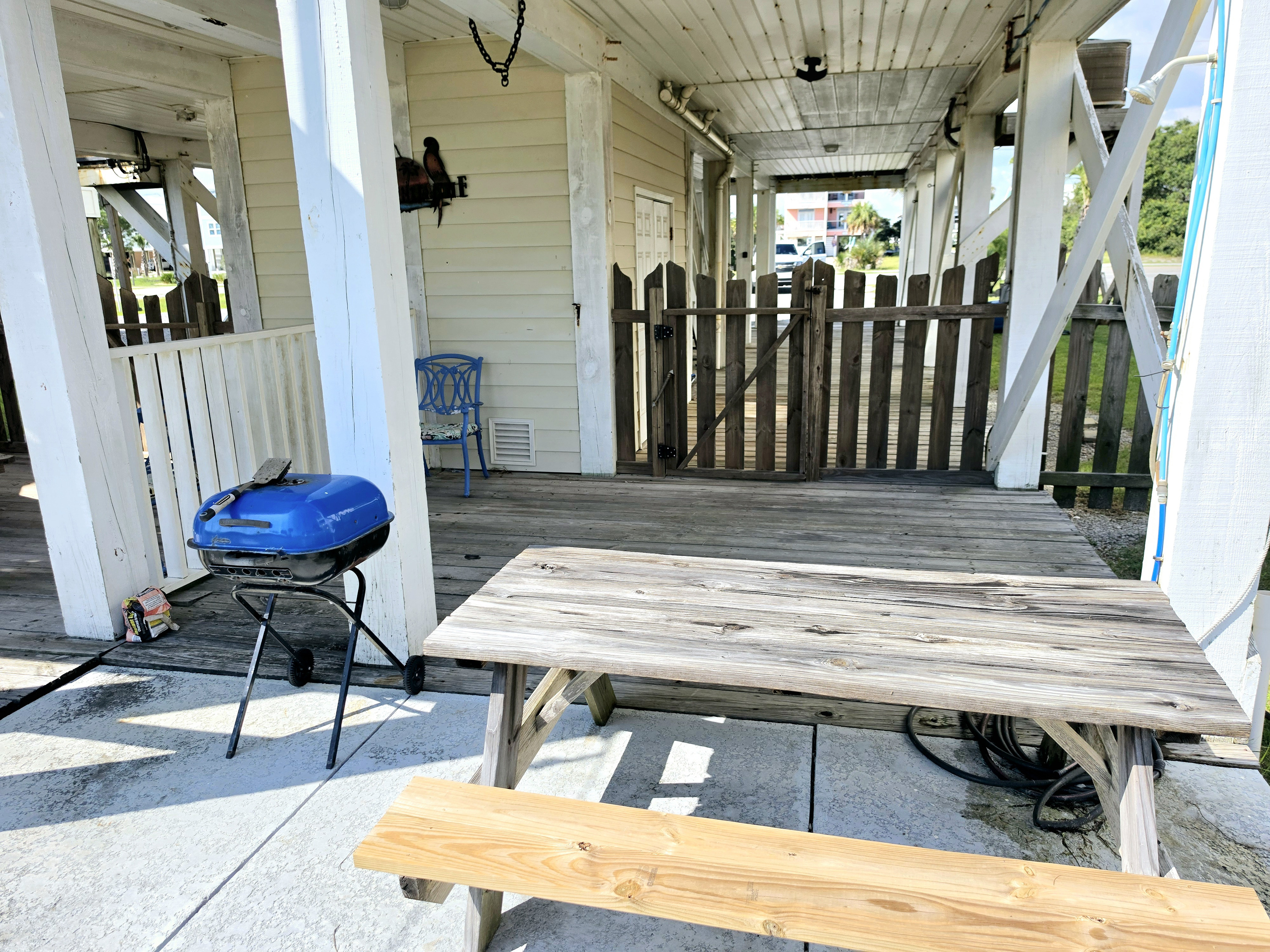 Covered patio with grill and picnic table
