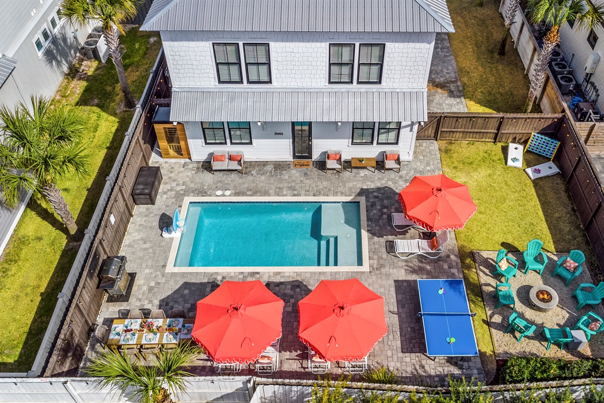 A private backyard oasis with pool, fire pit, outdoor dining, games, and plenty of space to relax.