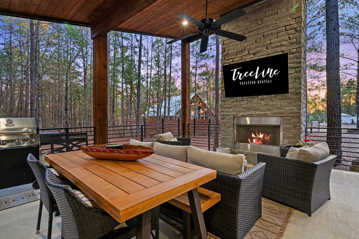 Outdoor dining feels especially inviting here, with a spacious table set among the trees.