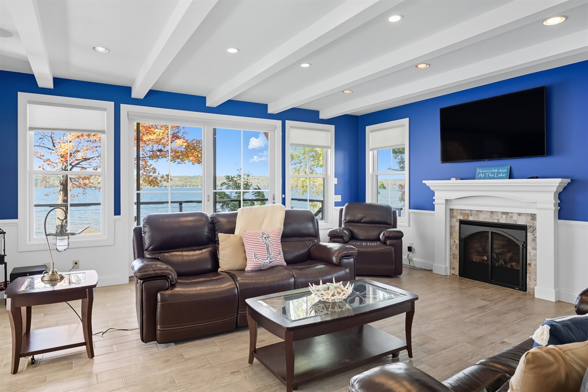 Spacious main floor living room with high ceilings, gas fire place and abundant natural light.