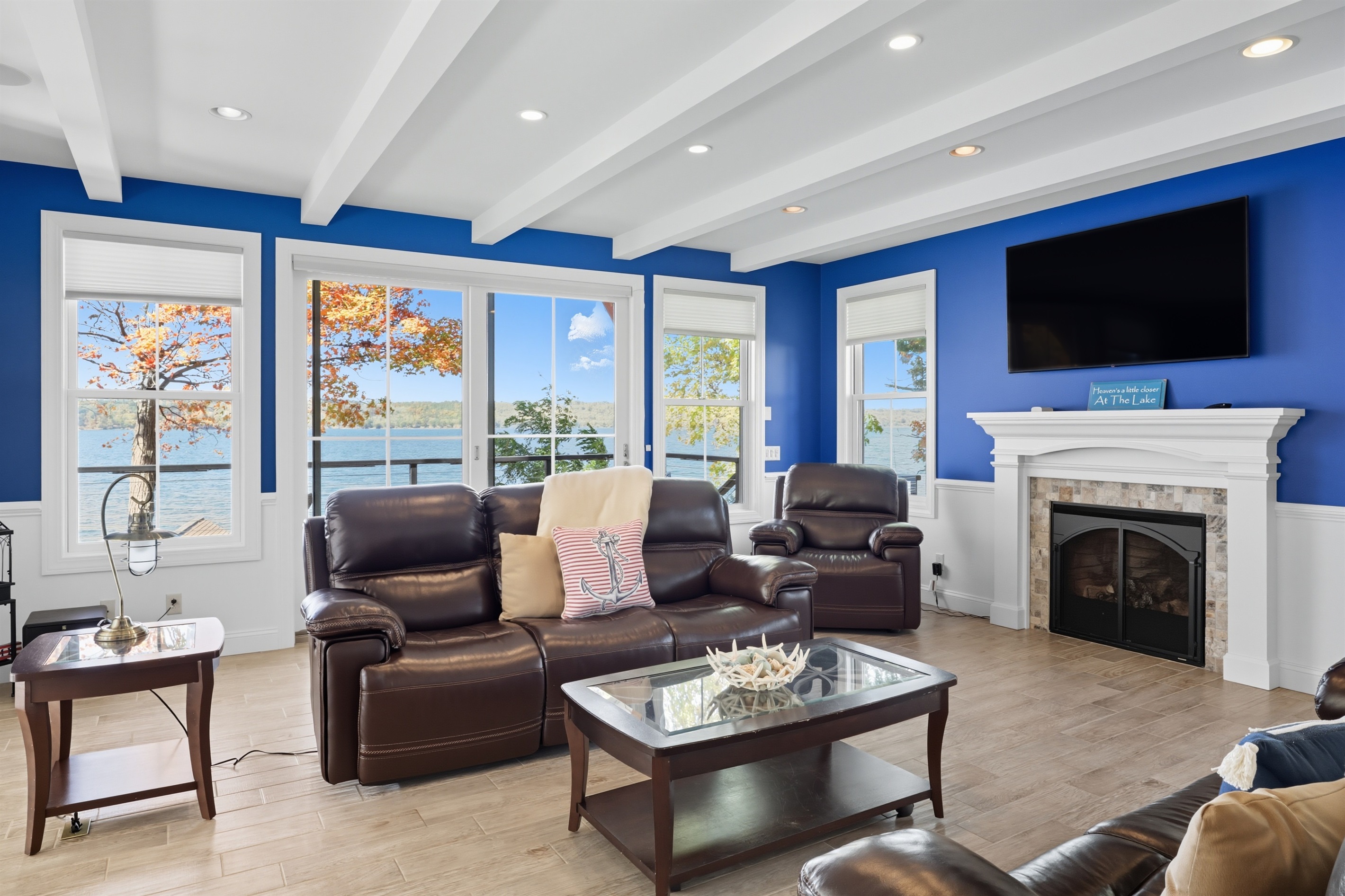 Spacious main floor living room with high ceilings, gas fire place and abundant natural light.