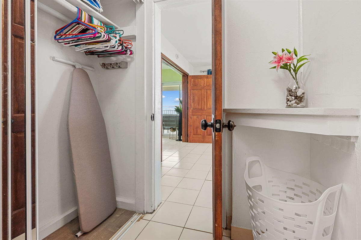 Hallway/closet space between the primary and guest bedroom