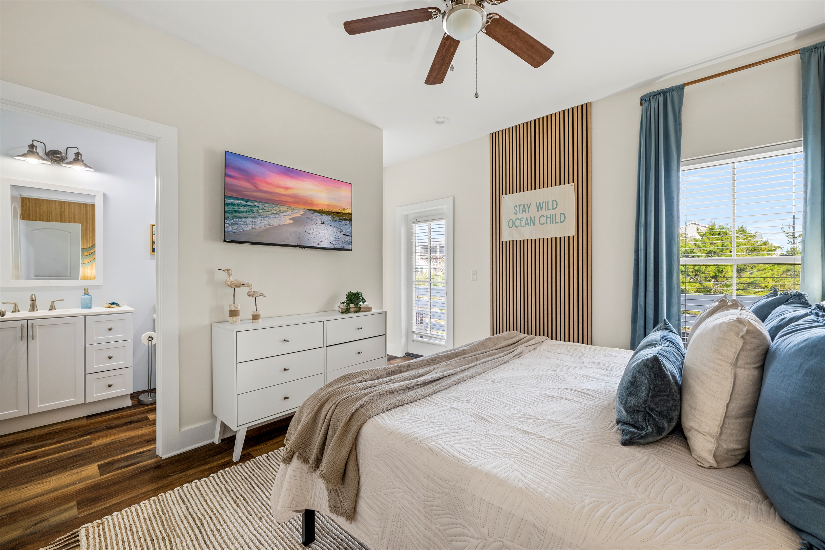 Stay wild, ocean child. This beach inspired bedroom brings calm coastal vibes and plenty of space to relax after exploring Miramar Beach.