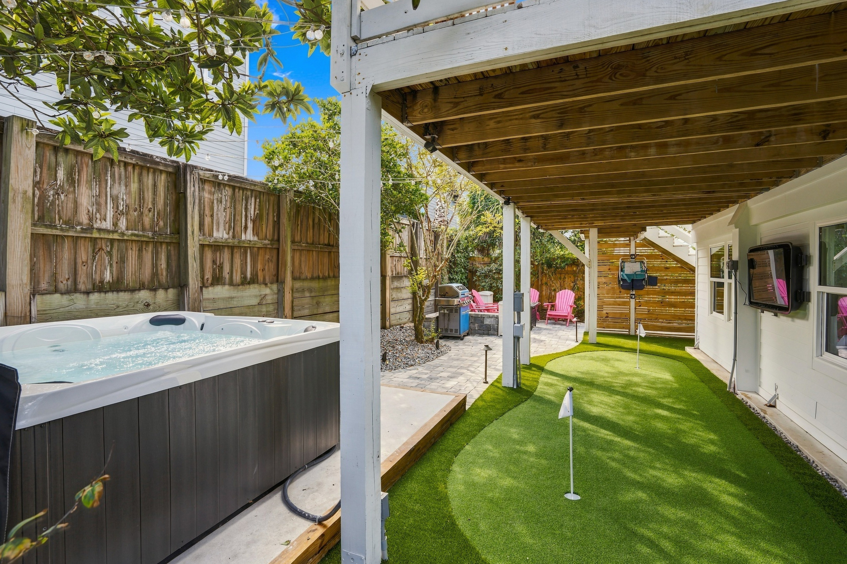 Hot tub, outdoor TV, and your own putting green—pick your favorite way to unwind in this private backyard.