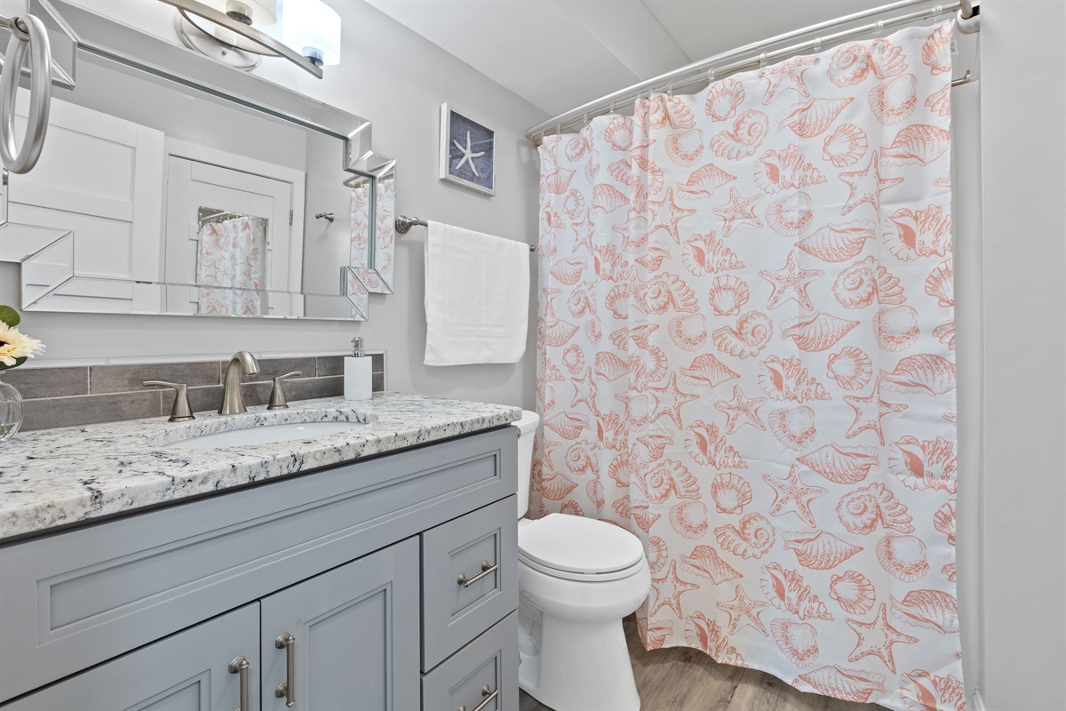 Guest bathroom with walk-in shower and coastal charm