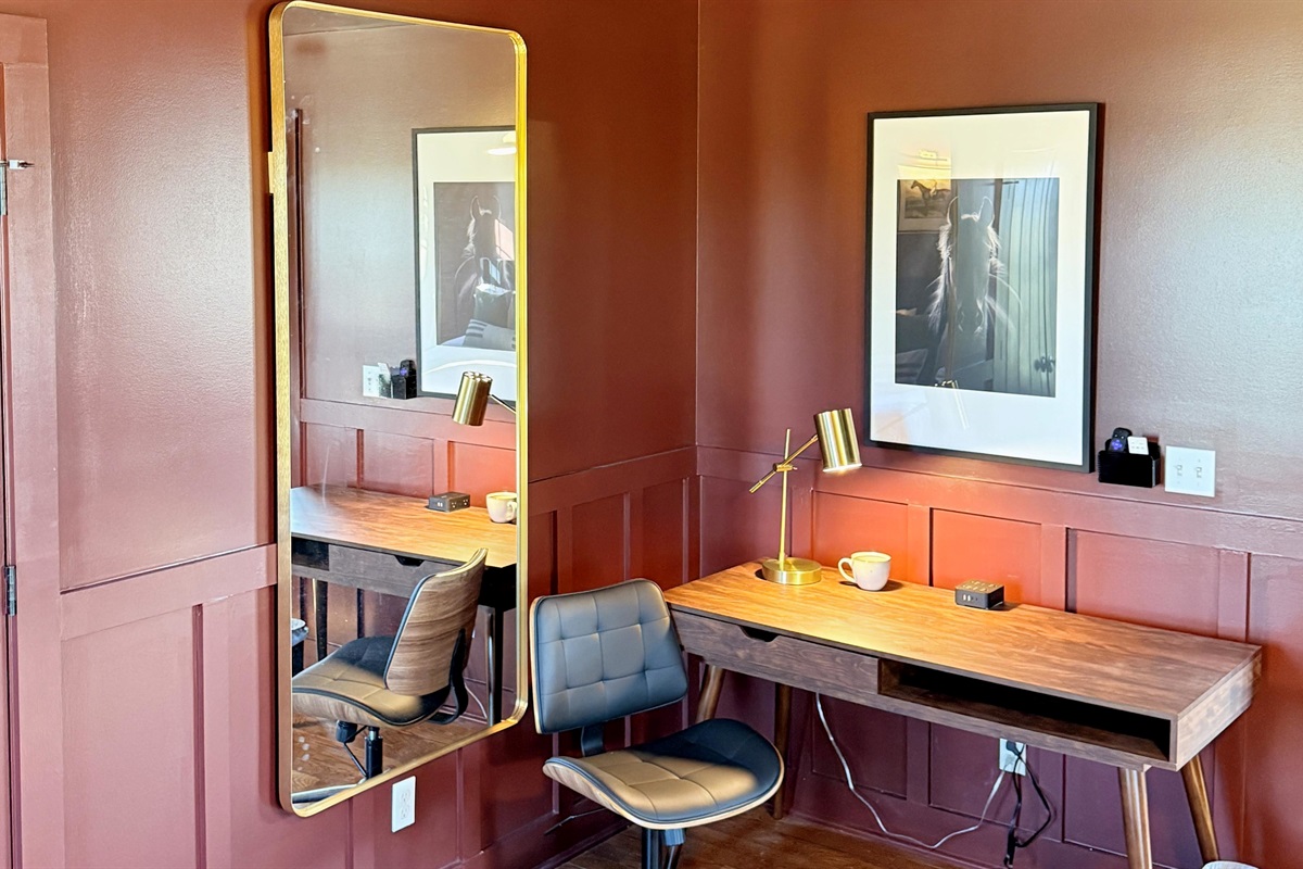 A polished workspace with Southern character — complete with brass lighting, leather accents, and equestrian art, this corner offers the perfect blend of focus and style for the modern traveler.