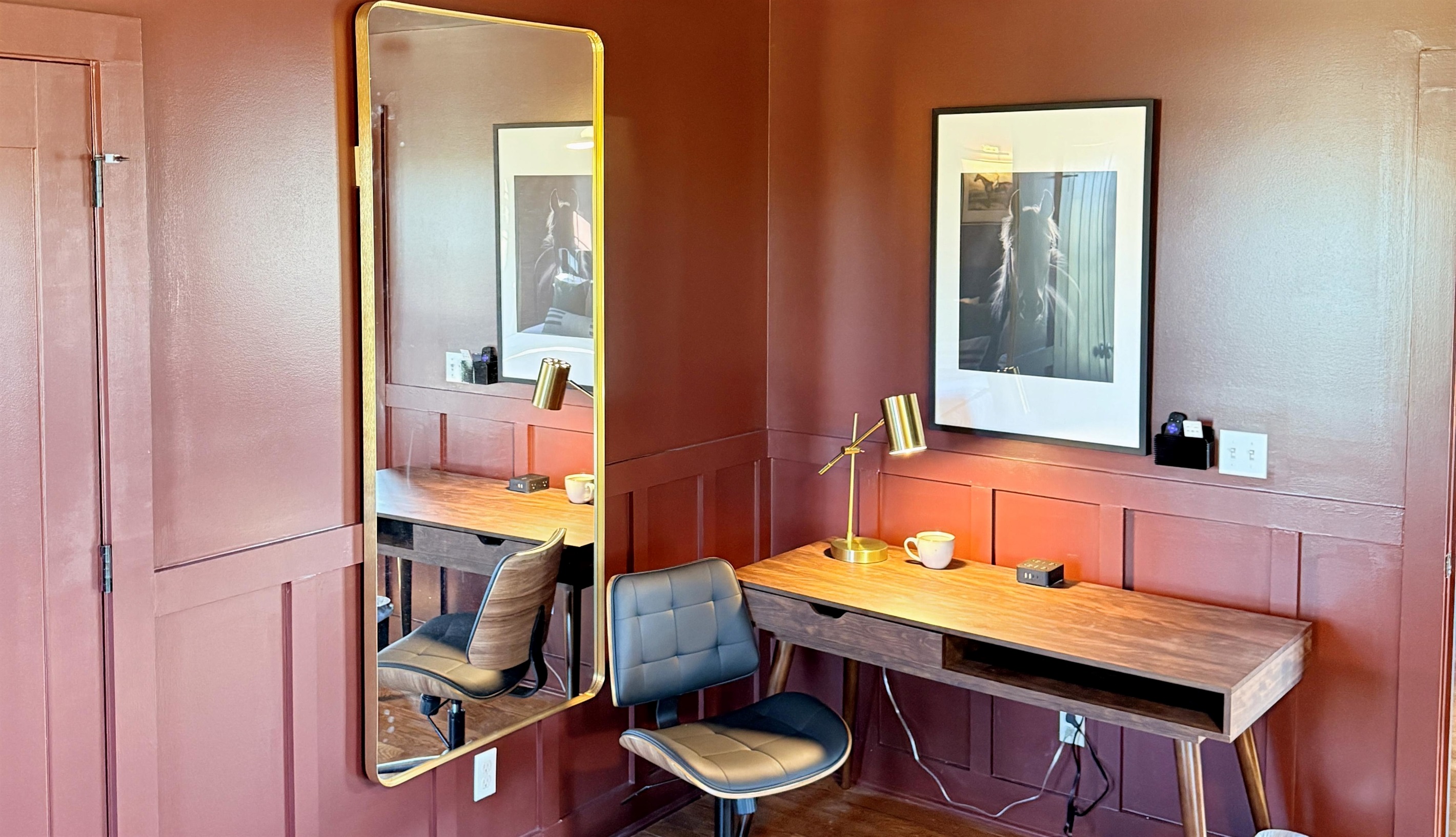 A polished workspace with Southern character — complete with brass lighting, leather accents, and equestrian art, this corner offers the perfect blend of focus and style for the modern traveler.