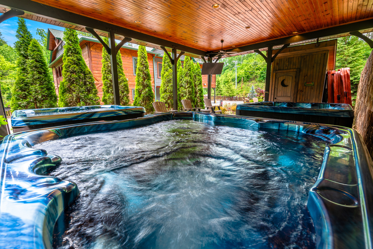 Three bubbling hot tubs with a TV and Exterior Bathroom. This is where your group ends every night. No waiting, no sharing — all three run simultaneously.