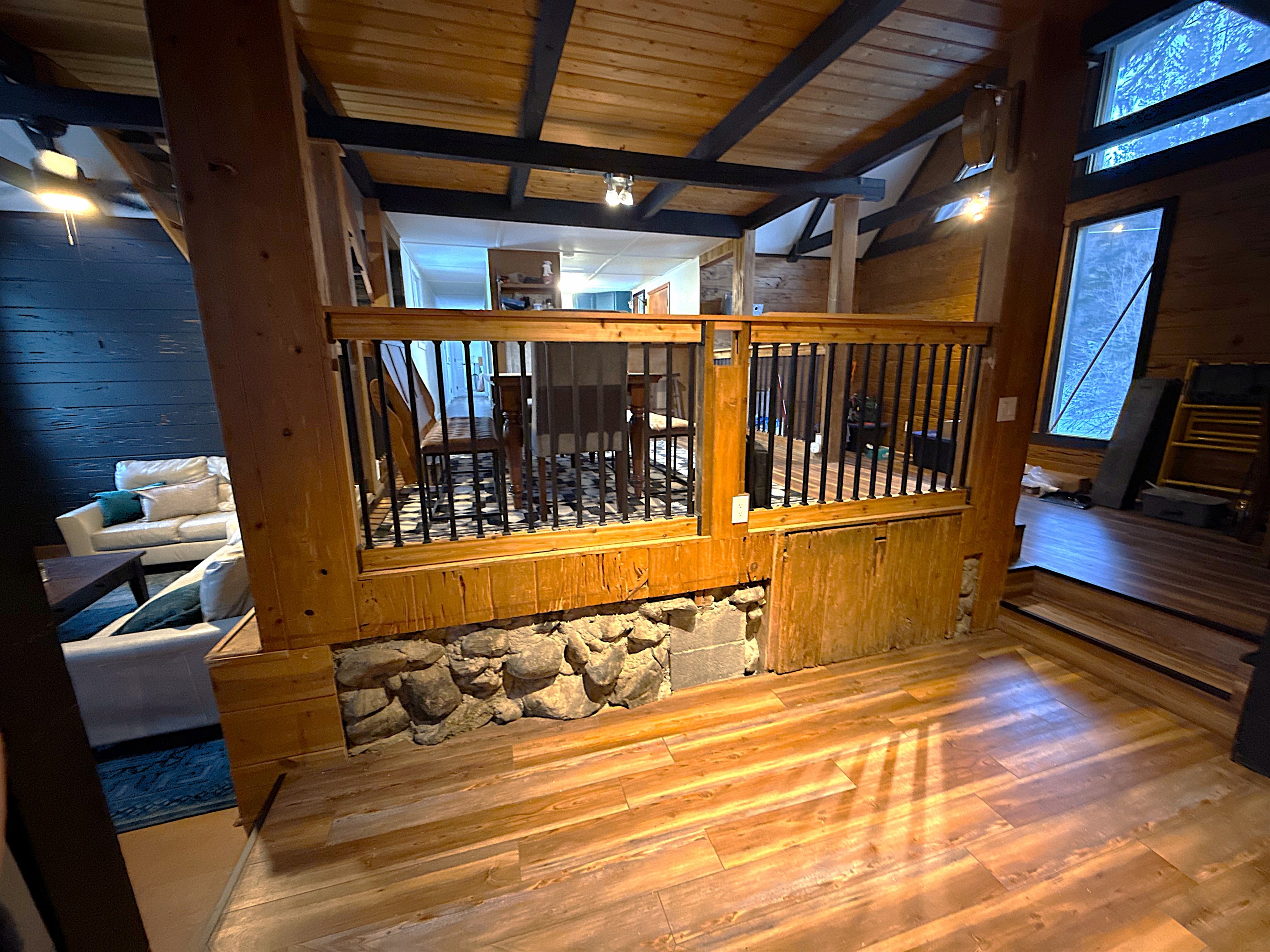 Gather around your rustic dining table under warm Edison bulbs—perfect for cozy meals, board games, or late-night chats in your private mountain-style retreat.