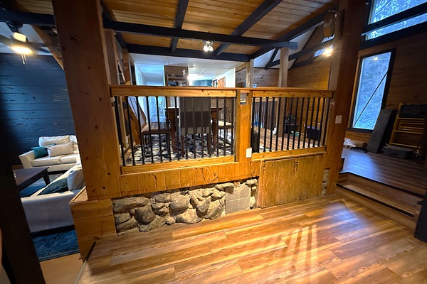 Gather around your rustic dining table under warm Edison bulbs—perfect for cozy meals, board games, or late-night chats in your private mountain-style retreat.