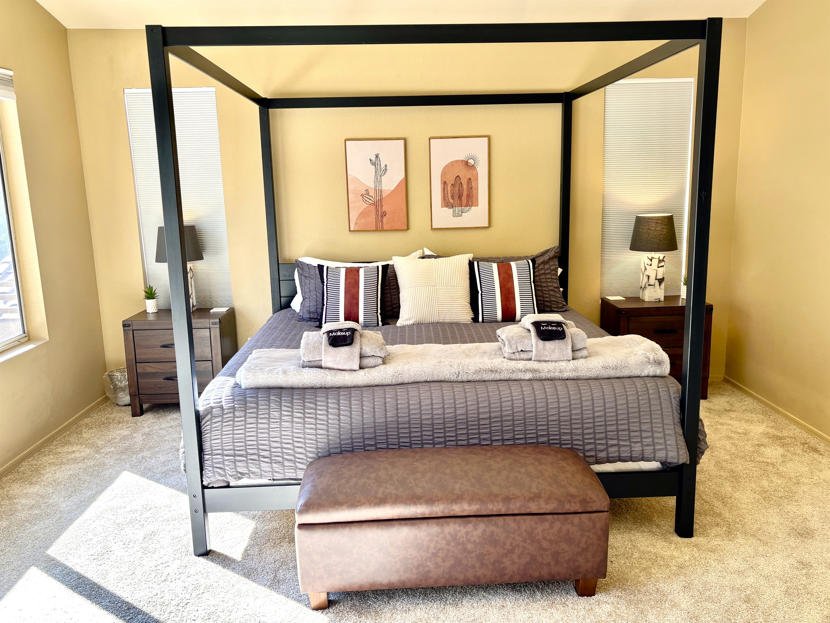 Primary suite with king bed, 55' smart tv, blackout blinds, ceiling fan, remote workstation, walk in closet, ensuite bathroom and private deck