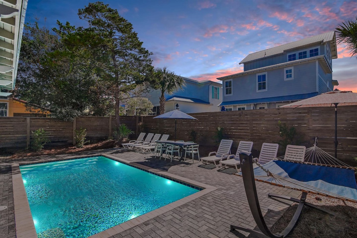 The private pool area features lounges, poolside tables and chairs, a hammock, and a grill.