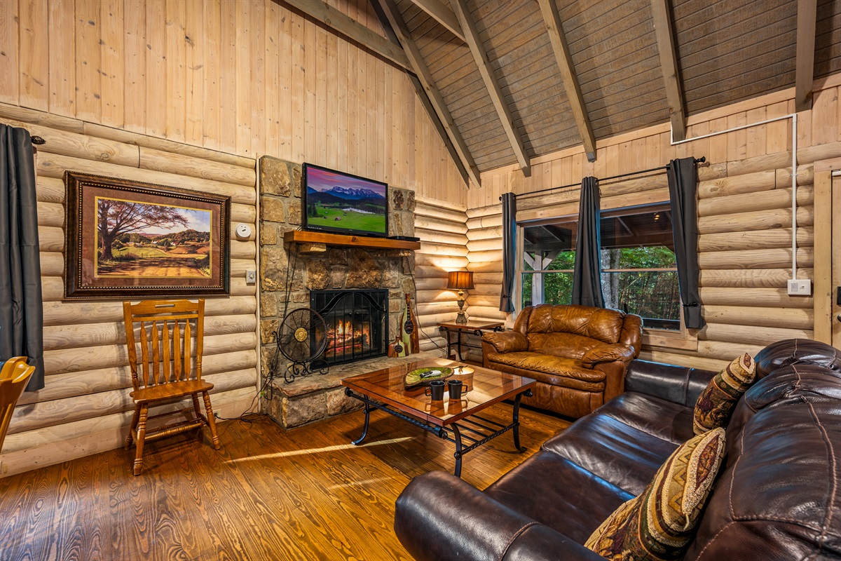 Relax by the stone fireplace in your plush mountain cabin living room.