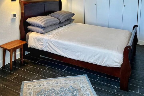Downstairs guest bedroom featuring stunning views and ample light. Accessible via an outside staircase.